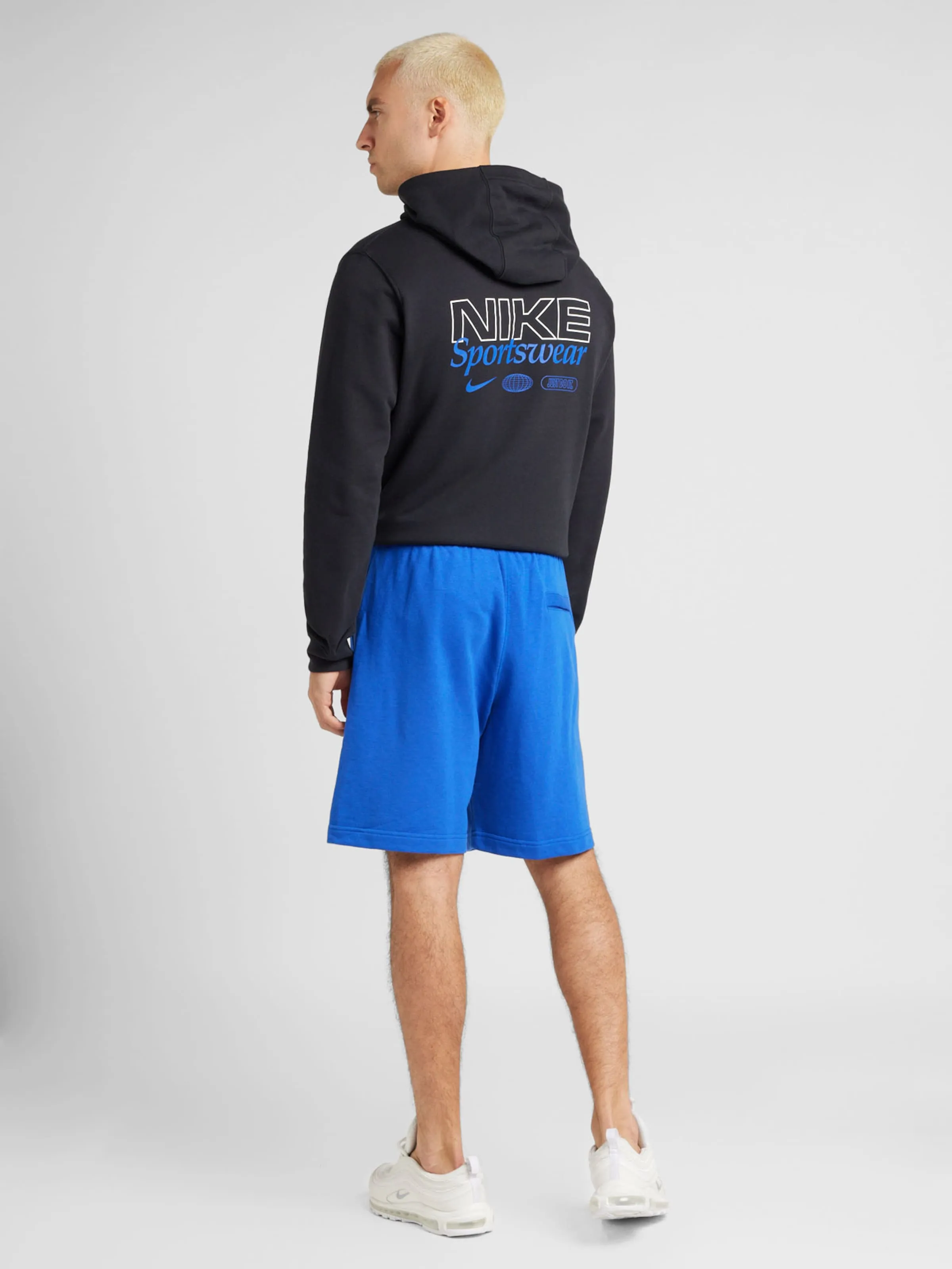 Loosefit Pantalón 'CLUB' Nike Sportswear en Azul Real